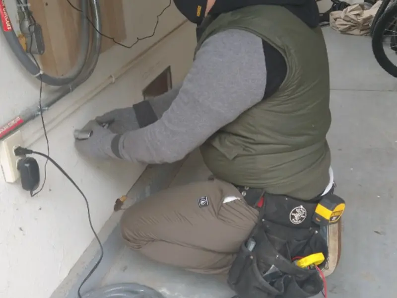 Electrician performing outlet wiring in a Gleed garage