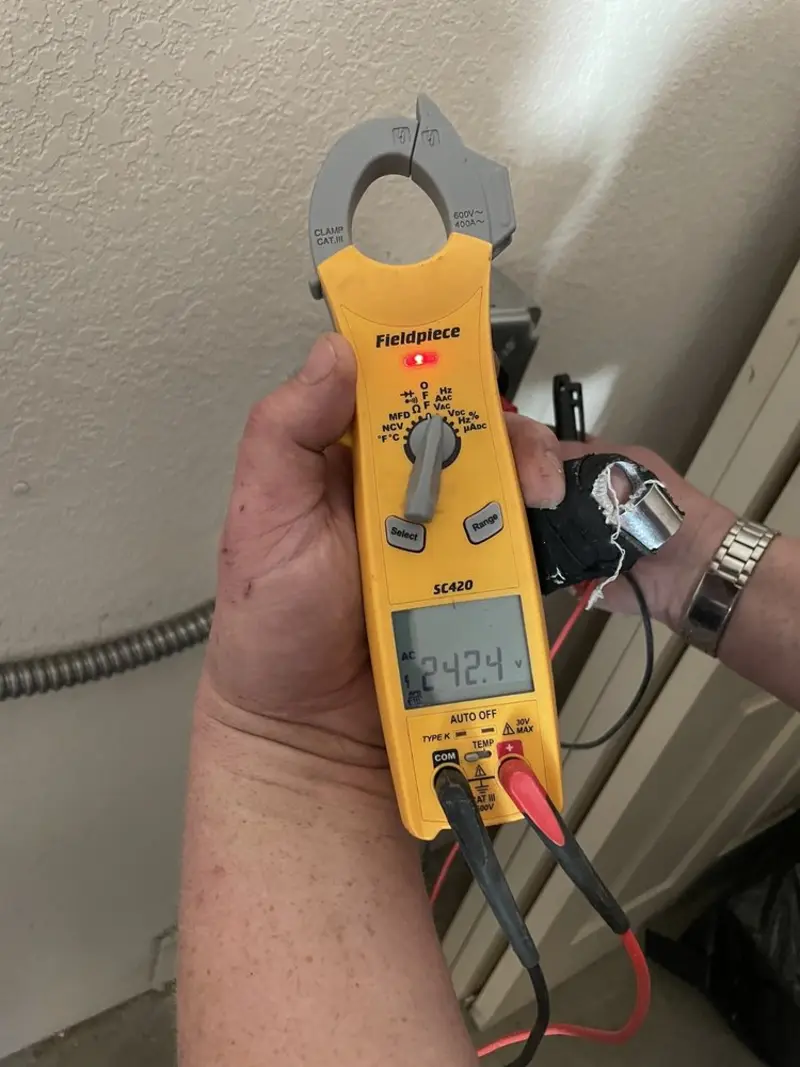 Voltage testing with clamp meter during Outlet Installation in Gleed